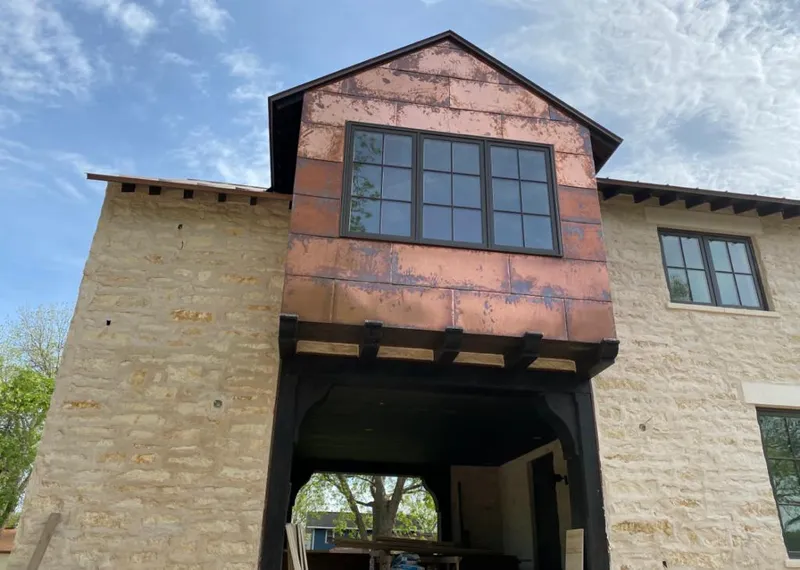 Copper metal panel facade on a stone building for Metal Roof Coating in Palmer